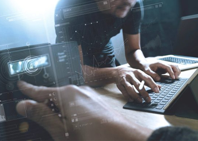 Value realisation office environment with two people working on screens, collaborating on tasks related to value management, emphasising teamwork and data analysis